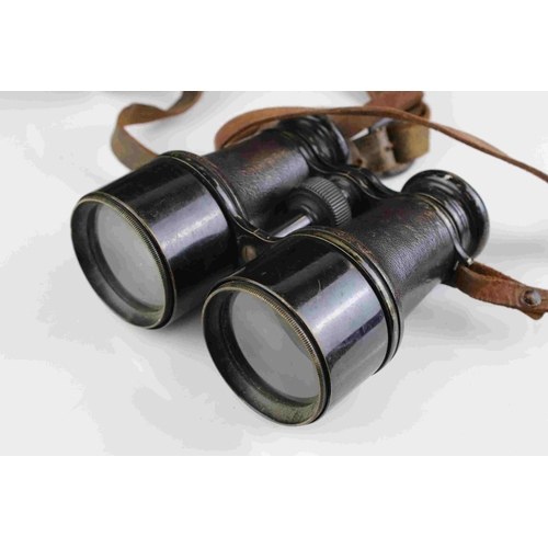 83 - A pair of world war one era British military issued field binoculars, marked with the broad arrow an... 