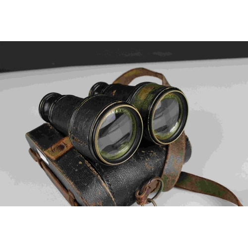 83 - A pair of world war one era British military issued field binoculars, marked with the broad arrow an... 