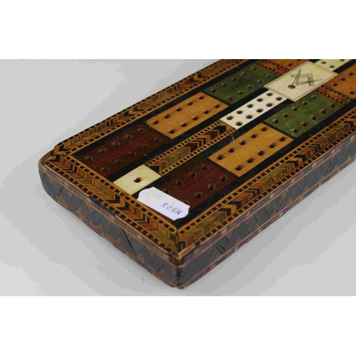 89 - A vintage decorative cribbage board with masonic marks to centre.