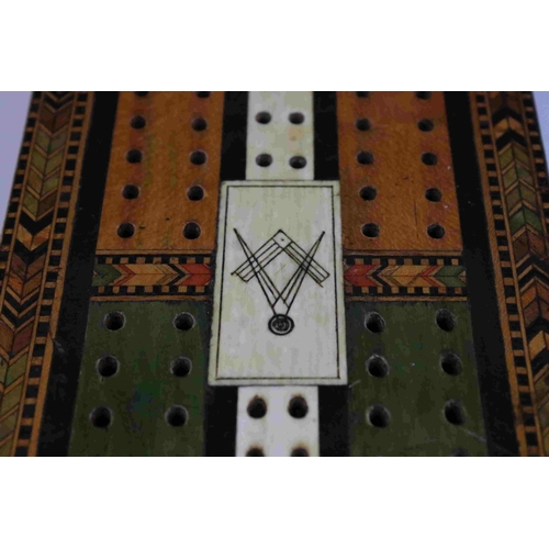 89 - A vintage decorative cribbage board with masonic marks to centre.