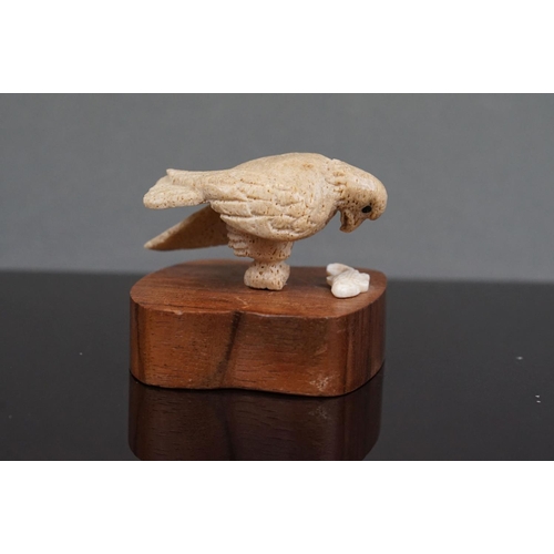 353 - A pair of Inuit carved Whale bone figures of birds of prey, one mounted to wooden base.