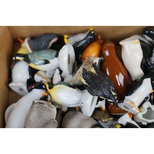 385 - A large collection of ornamental penguins to include ceramic examples.