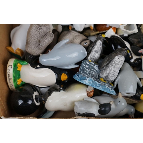 385 - A large collection of ornamental penguins to include ceramic examples.