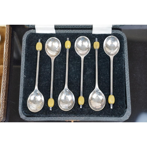 389 - A cased set of twelve silver plated knives and forks with mother of pearl handles and hallmarked sil... 