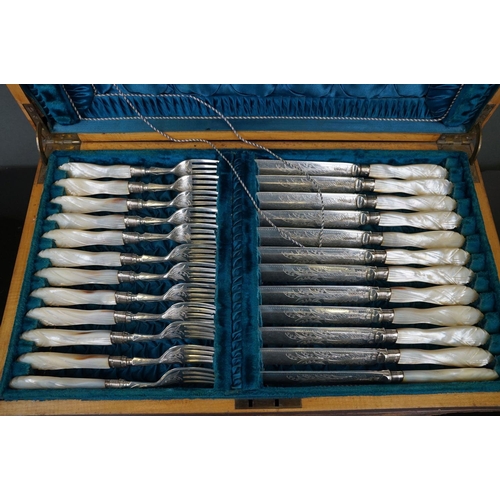 389 - A cased set of twelve silver plated knives and forks with mother of pearl handles and hallmarked sil... 