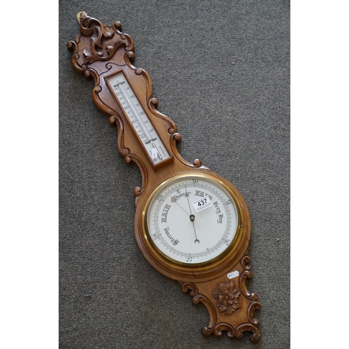 437 - A 20th century oak cased Barometer with carved and scalloped neck.