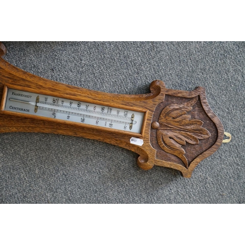 438 - An oak cased barometer, 20th century.