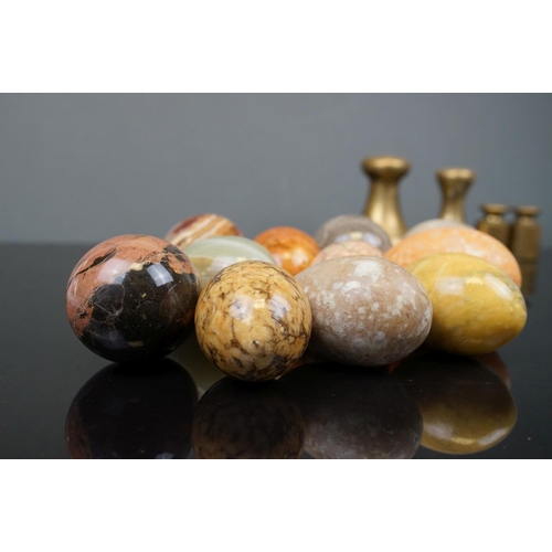 358 - A collection of eleven polished carved agate eggs together with a selection of Avery brass weights.