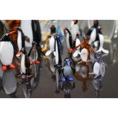 381 - A collection of glass Penguin figures to include Wedgewood and Murano examples.