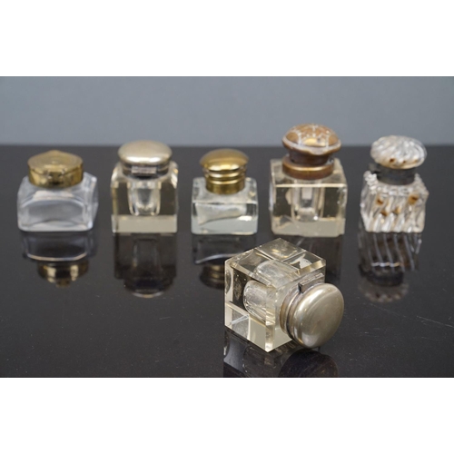 384 - A collection of six antique glass inkwells.