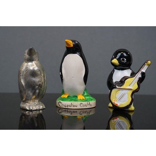 385 - A large collection of ornamental penguins to include ceramic examples.