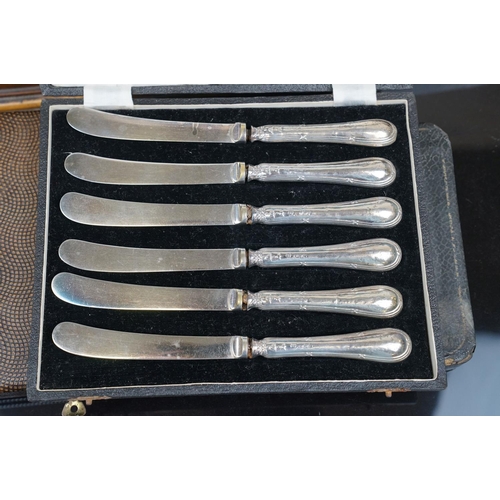 389 - A cased set of twelve silver plated knives and forks with mother of pearl handles and hallmarked sil... 