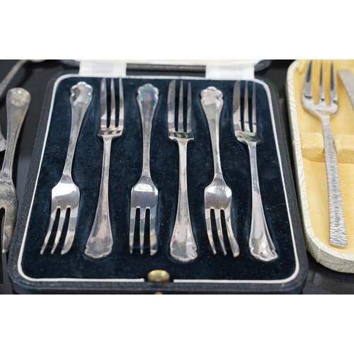 398 - A collection of silver plated cutlery to include cased knives and forks.