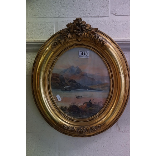 410 - An early 20th century oval gilt framed watercolour, mountain lake scene with fishermen and a steam p... 