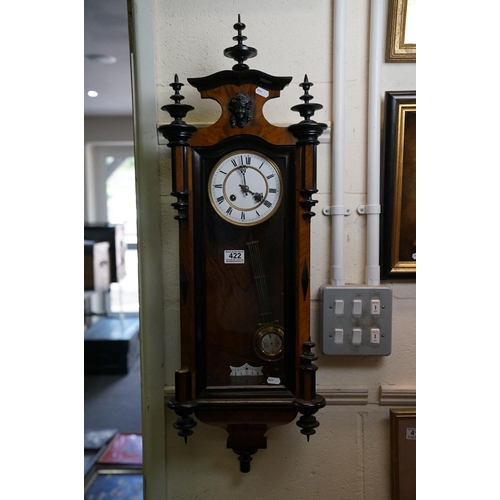 422 - An antique walnut cased Vienna Style wall clock with a two train movement.