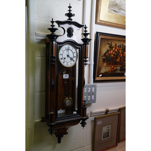 422 - An antique walnut cased Vienna Style wall clock with a two train movement.