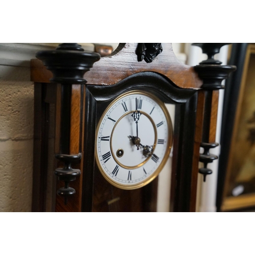 422 - An antique walnut cased Vienna Style wall clock with a two train movement.