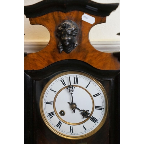 422 - An antique walnut cased Vienna Style wall clock with a two train movement.