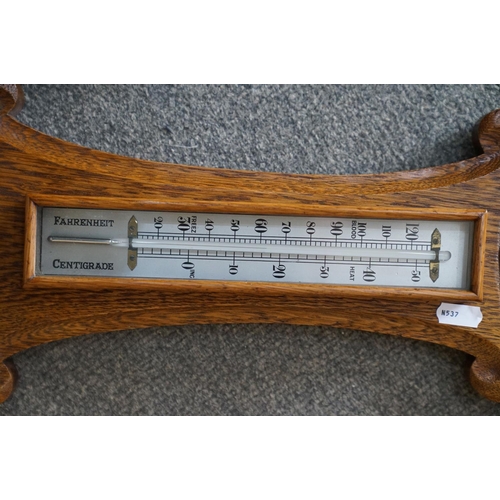 438 - An oak cased barometer, 20th century.