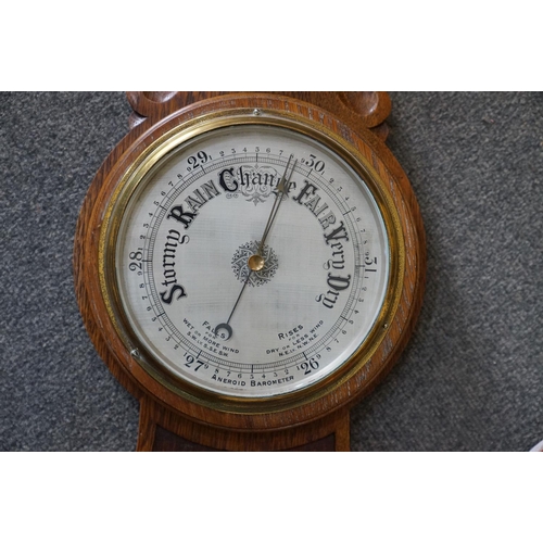 438 - An oak cased barometer, 20th century.