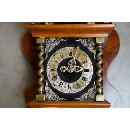 445 - A contemporary wooden wall clock with brass embellishments and a twin train movement.