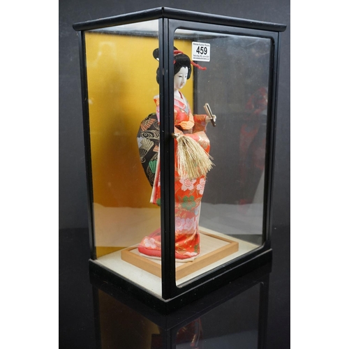 459 - A contemporary figure of a Geisha in a glass cabinet.