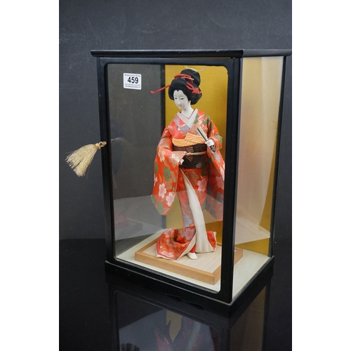 459 - A contemporary figure of a Geisha in a glass cabinet.