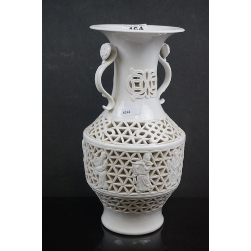 464 - An oriental Blanc de chine pierced vase together with a pair of early 20th century vases with huntin... 