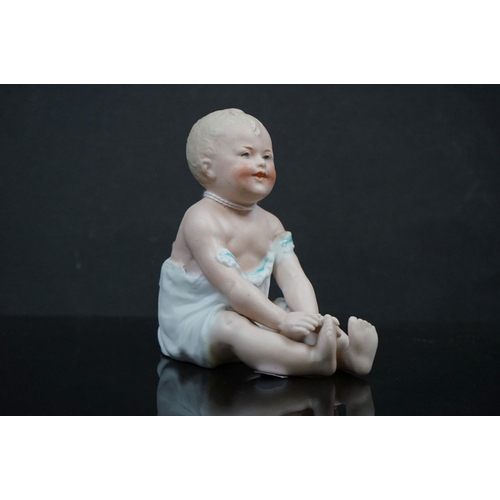 470 - A pair of Bisque china baby piano dolls