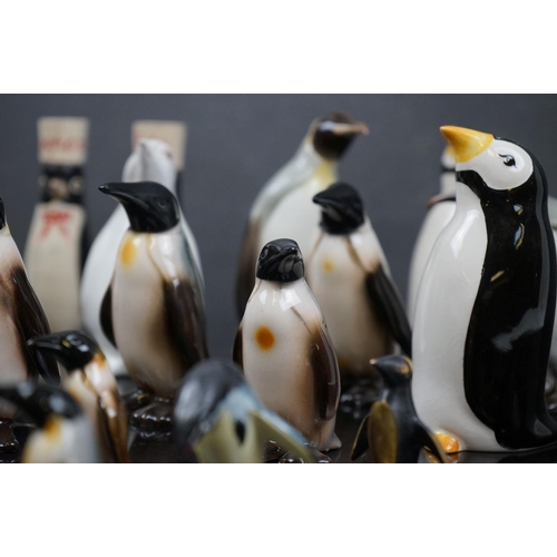 475 - A collection of ceramic Penguins to include Carlton Ware, Goebel and Coalport examples.