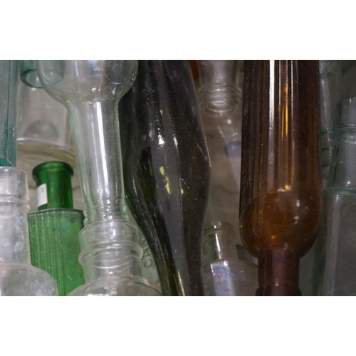 484 - A large quantity of antique glass bottles to include advertising and poison examples.