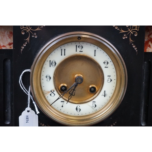 486 - A French slated mantle clock with decorative marble panels, complete with key.