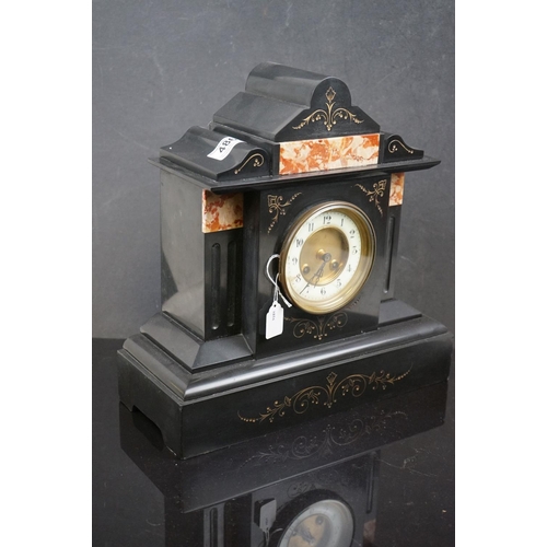 486 - A French slated mantle clock with decorative marble panels, complete with key.