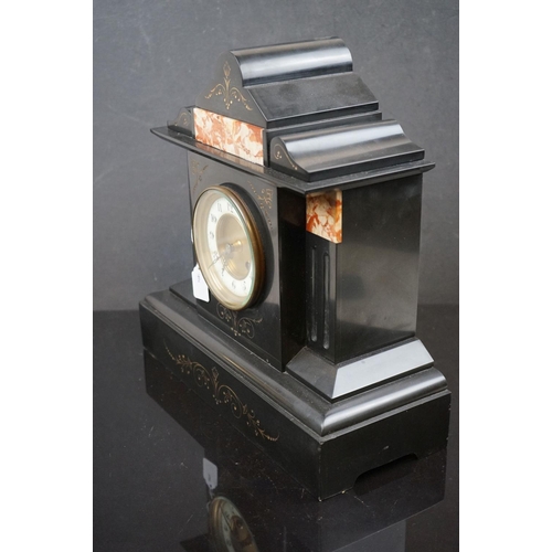 486 - A French slated mantle clock with decorative marble panels, complete with key.