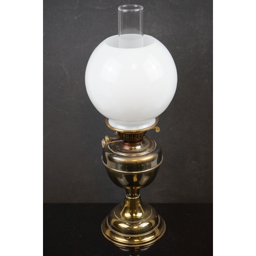 488 - A collection of five oil lamps to include four brass examples.