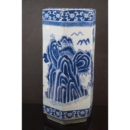 489 - A contemporary blue and white hexagonal Chinese stick stand with figures in a garden setting signed ... 