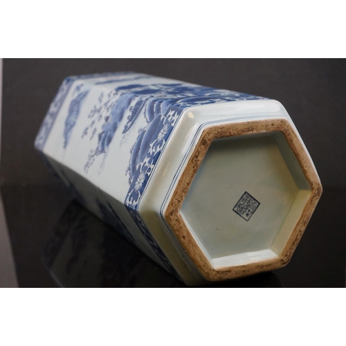 489 - A contemporary blue and white hexagonal Chinese stick stand with figures in a garden setting signed ... 