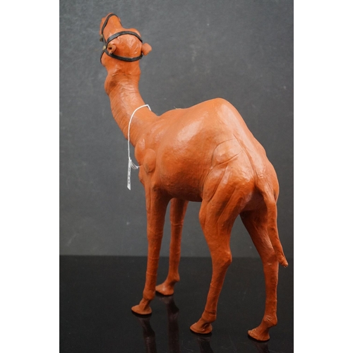 510 - A ornamental leather camel, stands approx 38cm in height.