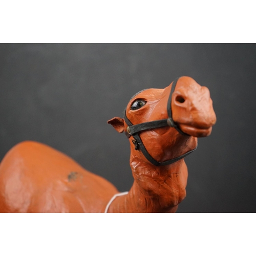 510 - A ornamental leather camel, stands approx 38cm in height.