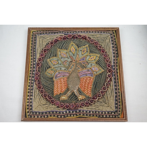 518 - A set of four framed Indian embroidered pictures.