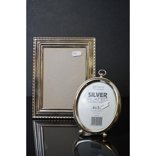 522 - Two silver plated photograph frames together with a black ceramic head.