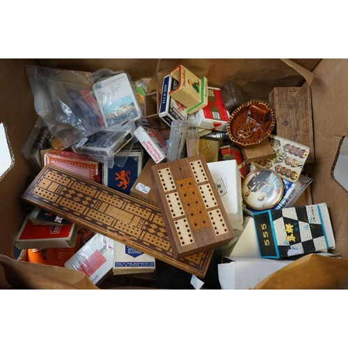 525 - A box of mixed collectables to include a quantity of playing cards.