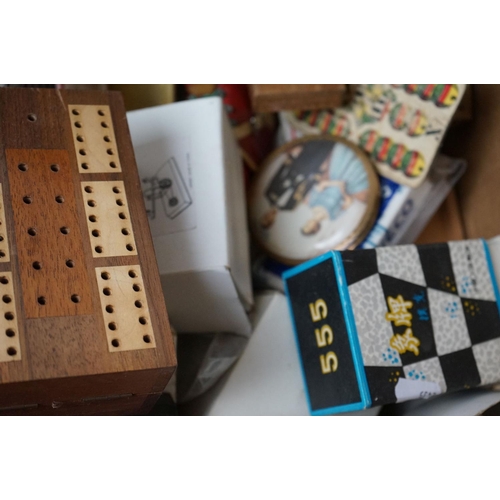 525 - A box of mixed collectables to include a quantity of playing cards.