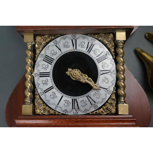 542 - A decorative contemporary wooden wall clock with brass embellishments and twin train movement.