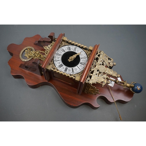 542 - A decorative contemporary wooden wall clock with brass embellishments and twin train movement.