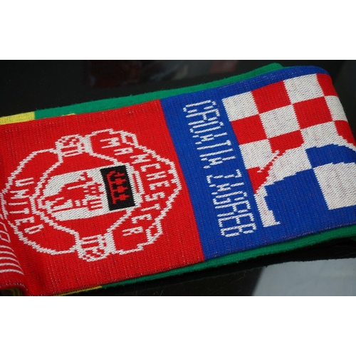 548 - A group of football related collectables to include scarf, book, figures and bags.