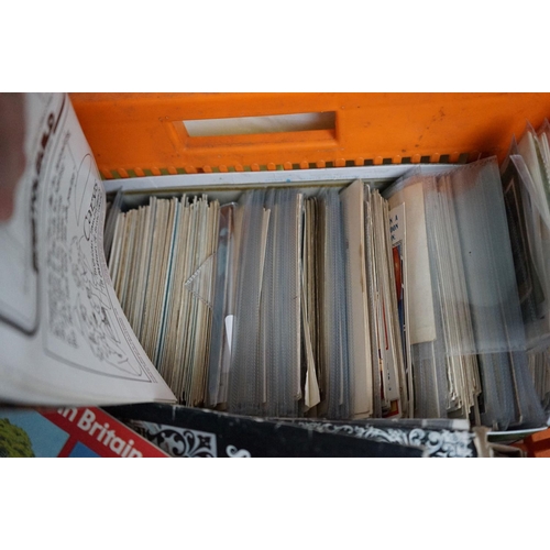 564 - A large collection of mixed ephemera contained within two boxes to include comics, postcards and tea... 