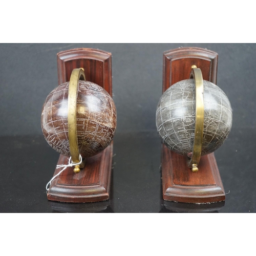 575 - A pair of wood bookends with resin globes.