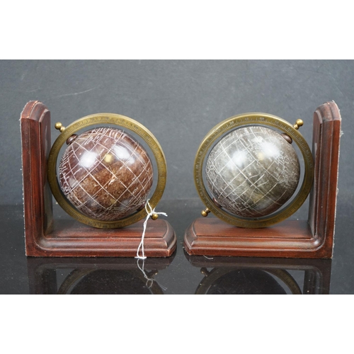 575 - A pair of wood bookends with resin globes.