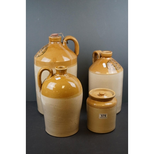 579 - A collection of four stoneware bottles to include two Bath advertising examples.